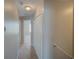 Upstairs hallway featuring carpet and white doors, providing access to bedrooms at 7462 Bentonshire Ave, Windermere, FL 34786