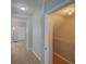Hallway with tile flooring and an open closet with shelving for ample storage at 7462 Bentonshire Ave, Windermere, FL 34786