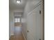 Hallway with tiled flooring leading to well-lit rooms adds practical elegance to the home at 7462 Bentonshire Ave, Windermere, FL 34786