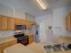 Modern kitchen with stainless steel appliances, wood cabinetry, and granite countertops at 7462 Bentonshire Ave, Windermere, FL 34786