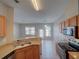 Bright kitchen featuring tile floors, stainless steel appliances, and access to the backyard at 7462 Bentonshire Ave, Windermere, FL 34786