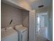 A well-equipped laundry room features a washer, a dryer and doorway at 7462 Bentonshire Ave, Windermere, FL 34786