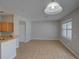Open living room with tile floors next to a breakfast bar and window at 7462 Bentonshire Ave, Windermere, FL 34786