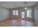 Bright and open living room with large windows and a glass door to the backyard at 7462 Bentonshire Ave, Windermere, FL 34786