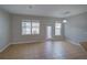 Bright living room with tile floors, a door to the outside, and large windows at 7462 Bentonshire Ave, Windermere, FL 34786
