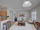 Comfortable living room featuring a couch, coffee table, side table, and access to kitchen at 7462 Bentonshire Ave, Windermere, FL 34786