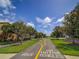 Scenic neighborhood street with tree-lined sidewalks and well-kept landscaping at 7462 Bentonshire Ave, Windermere, FL 34786