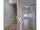 Carpeted stairway leading to the upper level with a bright, tiled hallway at 7462 Bentonshire Ave, Windermere, FL 34786