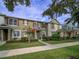 Attractive townhomes with red shutters and lush landscaping create appealing curb appeal at 7462 Bentonshire Ave, Windermere, FL 34786