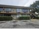 Two-story exterior showing balconies, walkway and parking, on a sunny day at 7900 S Orange Blossom Trl, Orlando, FL 32809
