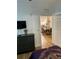 Bedroom with hardwood floors, a TV and a view of the dining room at 8010 Tuscany Way # 3102, Davenport, FL 33896