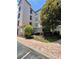 Exterior view of the condo building showcasing well-maintained landscaping and architectural details at 8010 Tuscany Way # 3102, Davenport, FL 33896