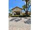 Welcoming clubhouse entrance with a covered entryway, beautiful stone pathway and manicured landscaping at 8010 Tuscany Way # 3102, Davenport, FL 33896