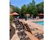 Inviting community pool area with lounge chairs and umbrellas for residents to relax and enjoy at 8010 Tuscany Way # 3102, Davenport, FL 33896