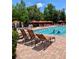 Inviting community pool area with lounge chairs and umbrellas for residents to relax and enjoy at 8010 Tuscany Way # 3102, Davenport, FL 33896
