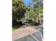Beautifully landscaped walkway to condos with stone accents and mature trees at 8010 Tuscany Way # 3102, Davenport, FL 33896