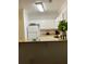 Kitchen with white cabinets, granite countertops, white appliances, and modern lighting at 8010 Tuscany Way # 3102, Davenport, FL 33896