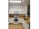 Modern kitchen with white cabinets, granite countertops, stainless steel appliances, and ample counter space at 8010 Tuscany Way # 3102, Davenport, FL 33896