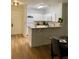 Bright kitchen featuring white cabinets, laminate countertops, and a breakfast bar at 8010 Tuscany Way # 3102, Davenport, FL 33896