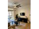 Living room with a ceiling fan, hardwood floors, black furniture, and sliding glass doors at 8010 Tuscany Way # 3102, Davenport, FL 33896