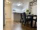 Open concept living and kitchen area with hardwood floors, modern fixtures, and dining set at 8010 Tuscany Way # 3102, Davenport, FL 33896