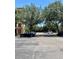 Large parking lot with several cars parked, trees, and surrounding landscaping in the community at 8010 Tuscany Way # 3102, Davenport, FL 33896