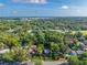 Expansive aerial view showing a neighborhood with mature trees and a distant lake at 815 E 11Th Ave, Mount Dora, FL 32757