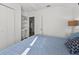Bedroom showcasing a closet, built-in shelves, blue bedding and access to another room at 815 E 11Th Ave, Mount Dora, FL 32757