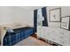 Bedroom features a daybed, dresser, dark curtains and hardwood floors at 815 E 11Th Ave, Mount Dora, FL 32757
