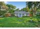 Charming single-story home with a bright blue front door and large manicured front lawn at 815 E 11Th Ave, Mount Dora, FL 32757