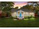 Charming single-story home with a vibrant blue front door and lush landscaping at 815 E 11Th Ave, Mount Dora, FL 32757
