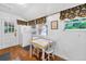 Cozy eat-in kitchen featuring a vintage table set, white appliances, and bright natural light at 815 E 11Th Ave, Mount Dora, FL 32757