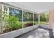 Relaxing screened porch offering peaceful views of the backyard's garden and landscaping at 815 E 11Th Ave, Mount Dora, FL 32757