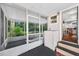 View of screened porch with access to inside kitchen and exterior lush tropical garden at 815 E 11Th Ave, Mount Dora, FL 32757