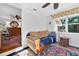Comfortable sitting area with colorful rug leads to a spacious home office at 815 E 11Th Ave, Mount Dora, FL 32757
