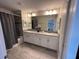Spacious bathroom featuring a double vanity with a shower and tub combo at 8934 Stinger Dr, Davenport, FL 33896