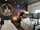 Whimsical space-themed bedroom with bunk beds and creative wall art, perfect for  at 8934 Stinger Dr, Davenport, FL 33896