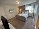 Well-lit bedroom with neutral color palette, carpeted floors, and a queen-size bed at 8934 Stinger Dr, Davenport, FL 33896