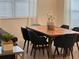 Dining area featuring a modern table, six chairs, and natural light from window at 8934 Stinger Dr, Davenport, FL 33896