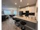 Modern kitchen with stainless steel appliances, white cabinets, and island with barstool seating at 8934 Stinger Dr, Davenport, FL 33896