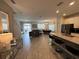 Open concept living area with kitchen island, dining space, and comfortable seating at 8934 Stinger Dr, Davenport, FL 33896