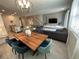 Open-concept living space with elegant dining table and cozy seating area for guests at 8934 Stinger Dr, Davenport, FL 33896