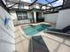 Relaxing pool area with lounge chairs and a safety fence in this inviting backyard space at 8934 Stinger Dr, Davenport, FL 33896