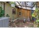 Backyard area featuring a covered area and foliage; a simple space with the potential for relaxation or storage at 905 Flewelling Ave, Ocoee, FL 34761