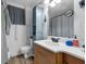 Bathroom featuring a wood vanity, updated lighting, and a grey storage cabinet at 905 Flewelling Ave, Ocoee, FL 34761