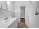 Bathroom showcasing a modern vanity, contemporary fixtures, and shower, which combines style with practical use at 905 Flewelling Ave, Ocoee, FL 34761
