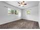 Bedroom featuring carpeted floors, white walls and two windows providing natural light at 905 Flewelling Ave, Ocoee, FL 34761