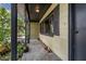 View of covered front porch with decor and views of lush green yard at 905 Flewelling Ave, Ocoee, FL 34761