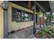 View of covered front porch with hanging plants and decor overlooking lush green yard at 905 Flewelling Ave, Ocoee, FL 34761
