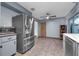 Bright kitchen with stainless steel refrigerator, ceiling fan and tile flooring at 905 Flewelling Ave, Ocoee, FL 34761